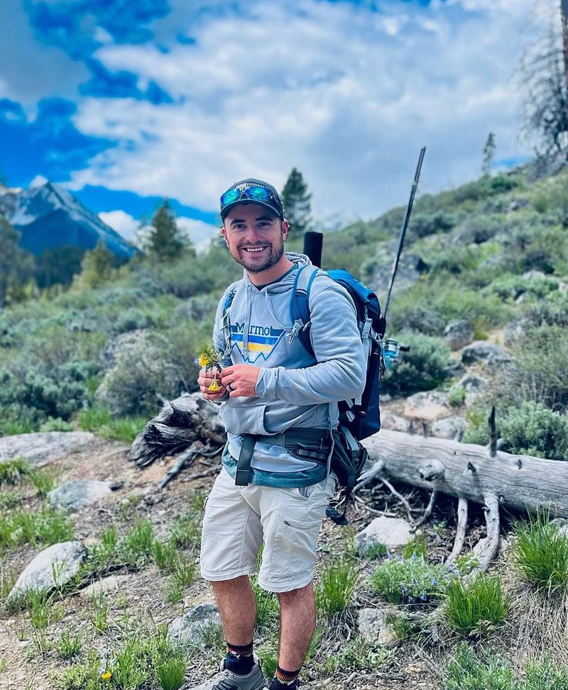 Brock hiking in the Idaho mountains with a fly rod in his pack